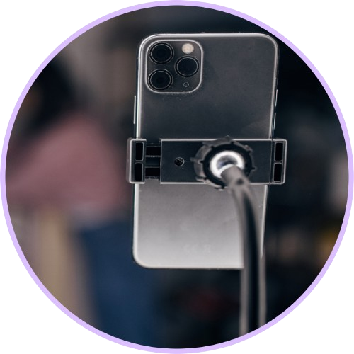 An iPhone is clipped to a phone holder.