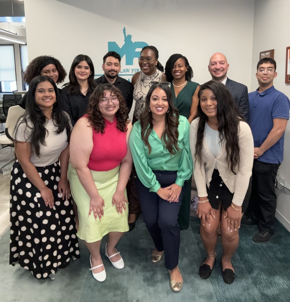 law team posing for photo inside office